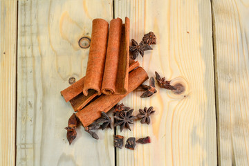 dried cinnamon and star anise close up isolated on wooden background