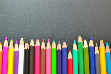 Close up of color pencils over black background