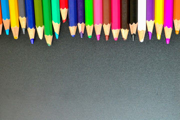 Close up of color pencils over black background