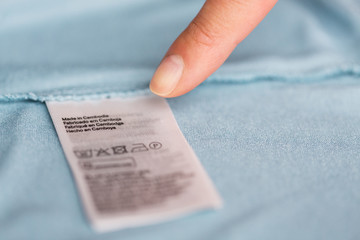 finger pointing to users manual of clothing