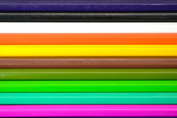 Close up of color pencils over black background