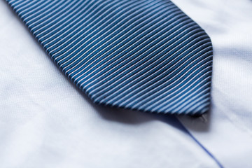 close up of shirt and blue patterned tie