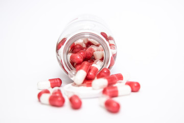 scattered pills out of the bottle isolated on white background.