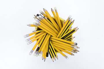 Bucket with yellow pencils from above in white background