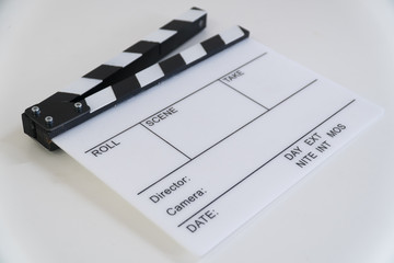 Clapboard on the table from the angle in white background