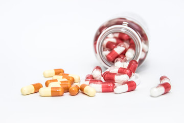 scattered pills out of the bottle isolated on white background.