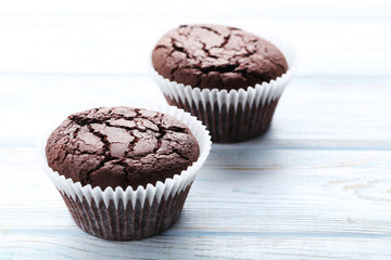 Chocolate muffins on a white wooden table