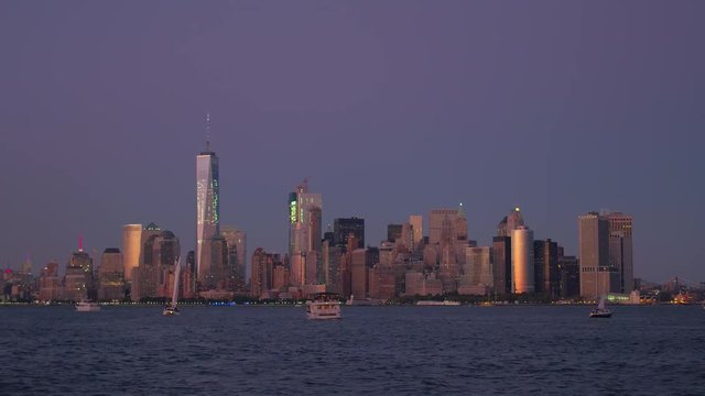 New York City lights and iconic Downtown Manhattan skyline on stunning evening