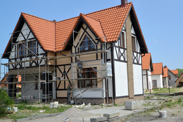 Fototapeta na wymiar KALININGRAD REGION, RUSSIA. Finishing works on a facade of a new cottage