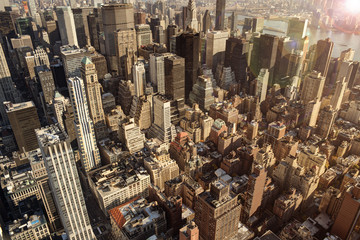 Fototapeta na wymiar New York city, close up on buildings and sunset in background. Aerial view