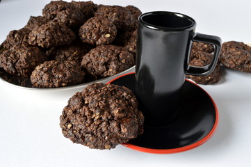 Homemade double chocolate oatmeal cookies with cup of coffee