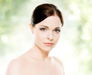 Close-up portrait of beautiful, fresh, healthy and sensual girl: over green background. Healthcare, spa, makeup and face lifting concept.