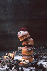 muffin with currants on a dark background next to the berries on the branches. and a bouquet of flowers. in a rustic style. dark style