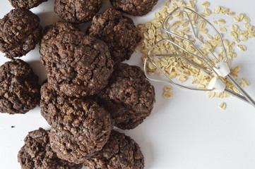 Homemade double chocolate oatmeal cookies with scattered oat flakes and mixer agitator