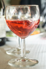 a glass of red wine stands on the table 