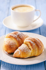 Homemade sweet croissants stuffed with cheese.