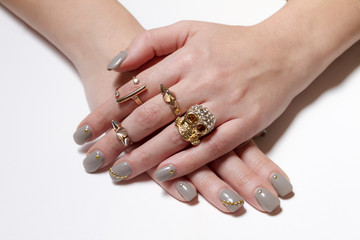 Various gold rings with nice manicured fingernails.