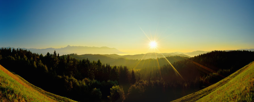 Summer High Tatras mountain landscape. Sunrise at monumental hills. Golden colored forest and peaks. Fog and inversion
