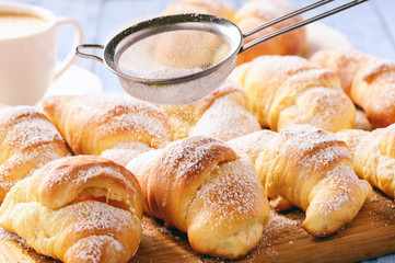 Homemade sweet croissants stuffed with cheese.