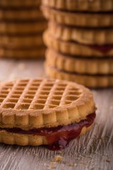 Several biscuits with homemade marmalade on light board