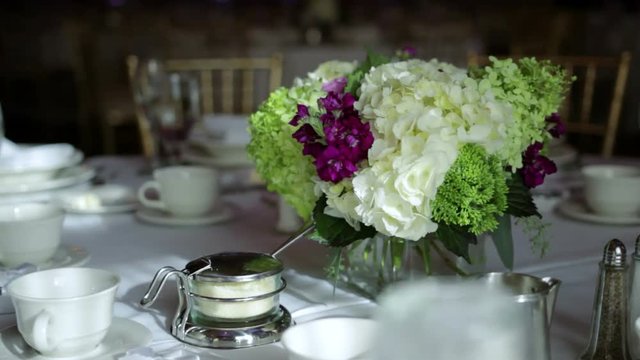 View of a flower arrangement on a set banquet table ready for an event.