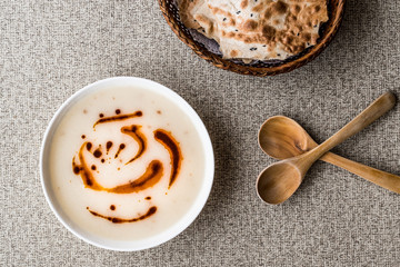 Turkish Soup Dugun Corbasi with fried butter sauce and crispy bread