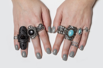 Various silver rock rings with nice manicured fingernails.