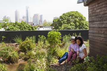 Boy (2-3) with mom in garden