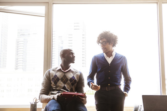 Two Men Talking In Office