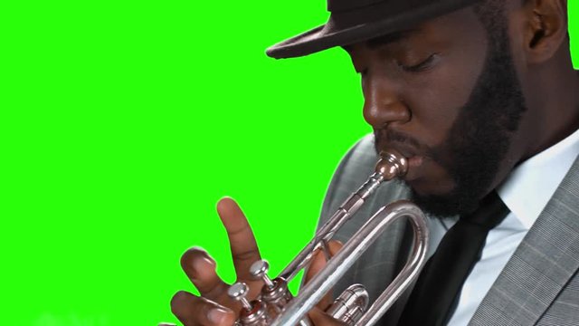 Trumpeter in a hat. Black man with a trumpet.