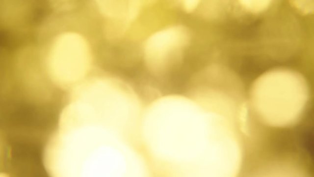 gold sparkle background with optical blurred effect - large bright
