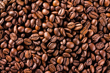 Macro image of brown roasted coffee beans background.