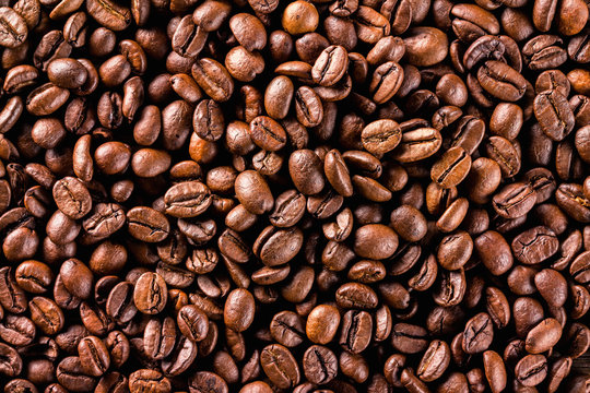 Macro image of brown roasted coffee beans background.