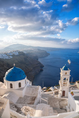 Santorini island with church against sunrise in Greece