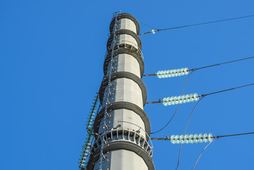 Supports high-voltage power lines against the blue sky