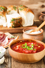 Beet soup borscht  with garlic buns and cured pork belly, Ukrainian cuisine