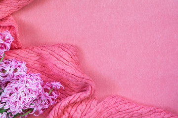 Beautiful spring holiday background. Fresh white hyacinth and pink woven scarf on pink copy space groundwork.