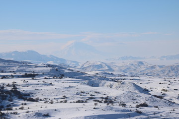 Fantastic winter panorama of the range of mountains with the peak of Ararat at the background. It's a great success to see the peak of Ararat in winter as it is almost always covered with clouds