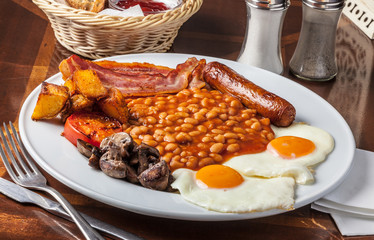 Brunch platter with eggs, beans,sausage and bacon.