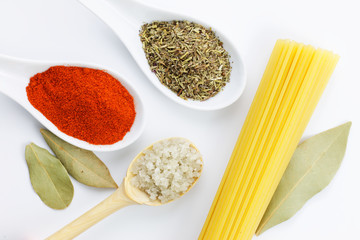 Various spices oregano, coriander seeds, bay leaves, cumin seeds and spaghetti