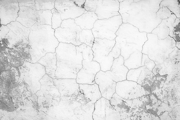 Close-up of a cracked and weathered concrete wall texture in black&white.