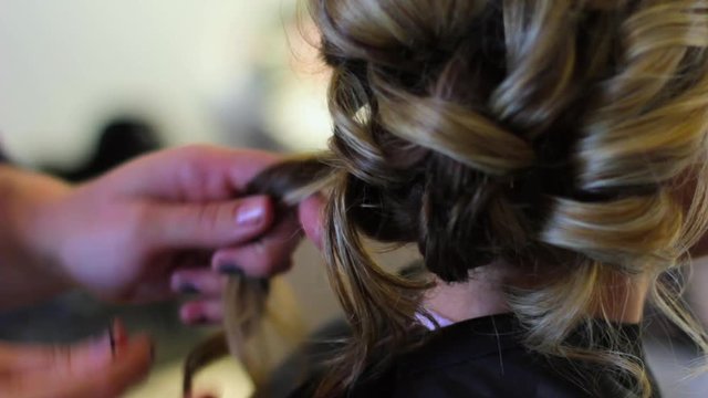 Hair stylist working on a bride's hair.