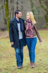 Couple walking through a park