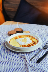 Delicious cheese casserole in a ceramic pot.