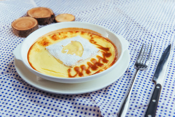 Delicious cheese casserole in a ceramic pot.