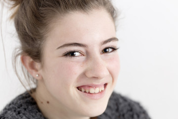 Closeup of young woman smiling.