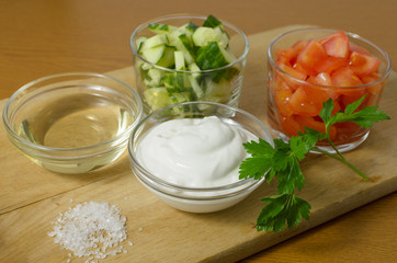 Salad with cucumbers, tomatoes and sour cream, mayonnaise.