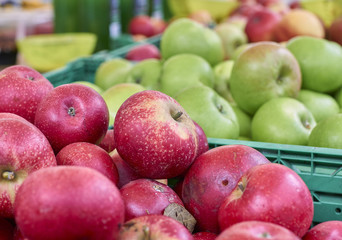 Rustic red and green apples on a market stall detail