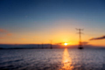 Fototapeta na wymiar electric line above water during a fantastic sunset. Natural blu