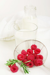 Fresh raspberry with milk on white